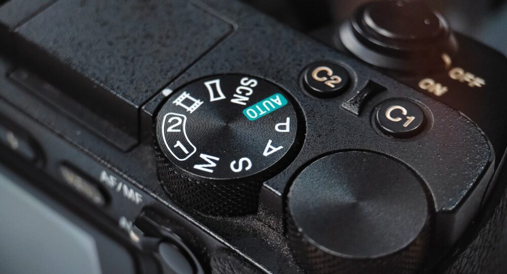 Close-up of a camera mode dial with settings.