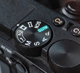 Close-up of a camera mode dial with settings.