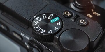 Close-up of a camera mode dial with settings.