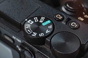 Close-up of a camera mode dial with settings.