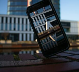 a cell phone sitting on top of a wooden table
