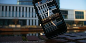 a cell phone sitting on top of a wooden table