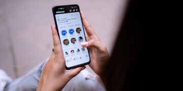 a person holding a cell phone in their hand