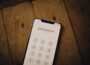 a cell phone sitting on top of a wooden table