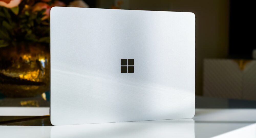 A white laptop sitting on top of a table