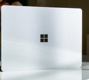 A white laptop sitting on top of a table
