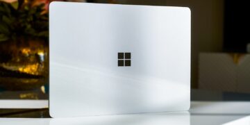 A white laptop sitting on top of a table
