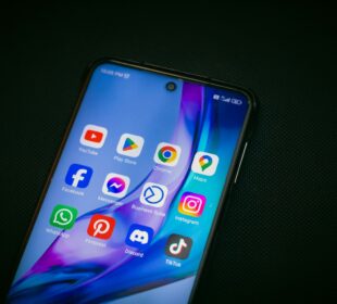 a close up of a cell phone on a black surface