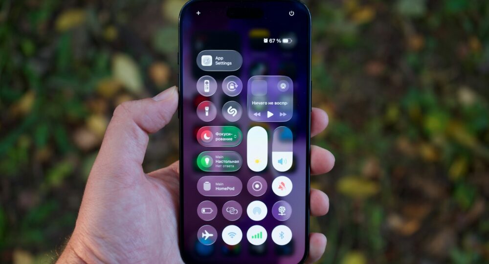 Hand holding a smartphone with colorful app icons.