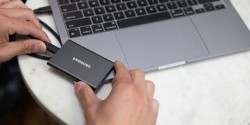 a person holding a laptop