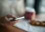 selective focus photography of person holding gray phone