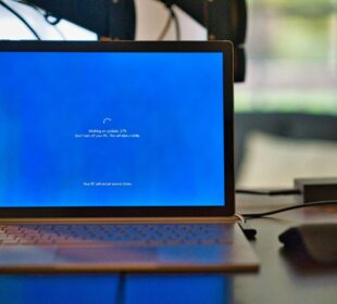 macbook pro on brown wooden table