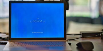macbook pro on brown wooden table