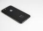 Black smartphone placed on a clean white surface, highlighting modern design and tech elegance.