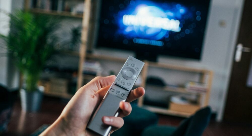 person holding gray remote control