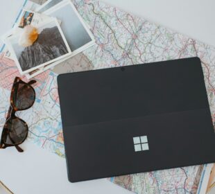 a laptop computer sitting on top of a white table