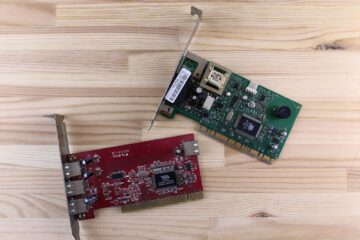 a raspberry board and a mouse on a wooden surface