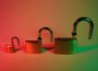 two green padlock on pink surface