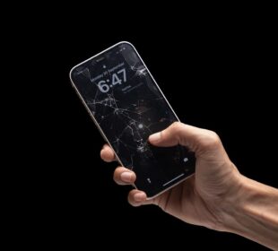 A person holding a cell phone in their hand