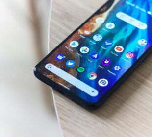 black android smartphone on brown wooden table