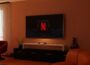 a living room with a flat screen tv on the wall