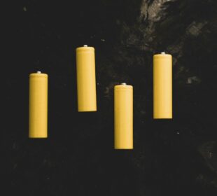 yellow pillar candles on black surface