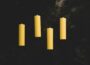 yellow pillar candles on black surface