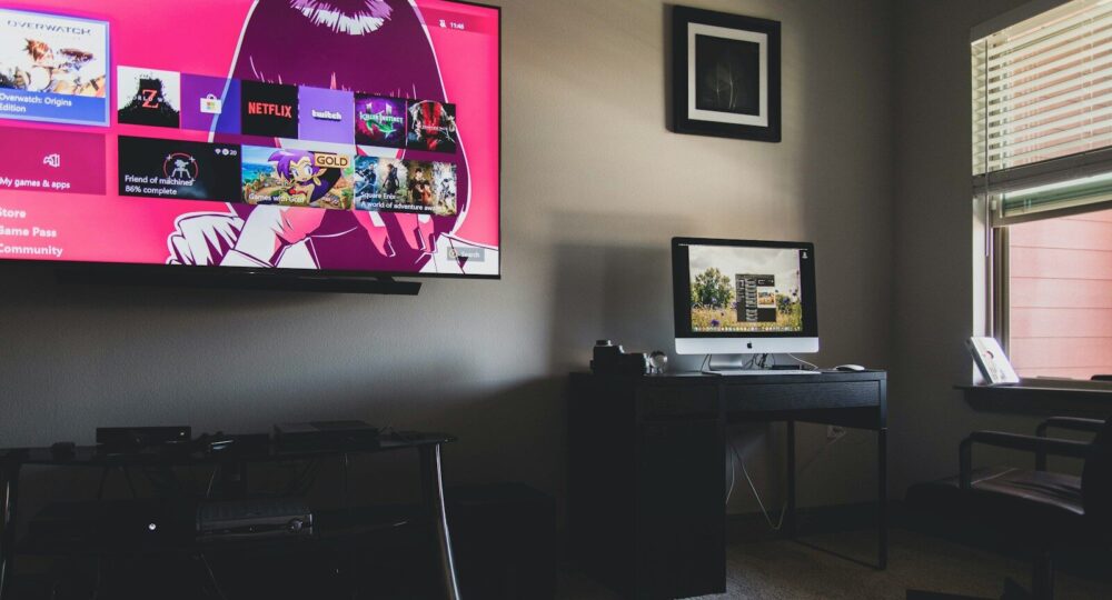 black flat screen tv turned on near black wooden table