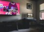 black flat screen tv turned on near black wooden table