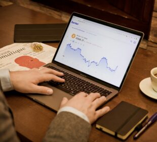 a person using a laptop on a wooden table