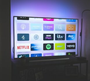 black flat screen tv turned on showing game
