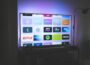 black flat screen tv turned on showing game