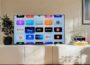 a flat screen tv sitting on top of a white cabinet