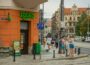 Urban street view in Wrocław, Poland, featuring people, cafes, and bustling city life.