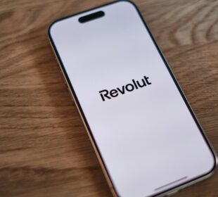 A cell phone sitting on top of a wooden table