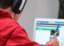 person in red shirt wearing black and gray headphones