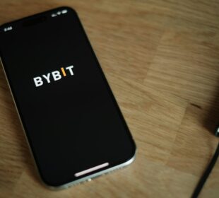 A cell phone sitting on top of a wooden table