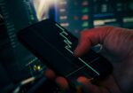 Trader analyzing stock market data on smartphone and phone