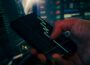 Trader analyzing stock market data on smartphone and phone